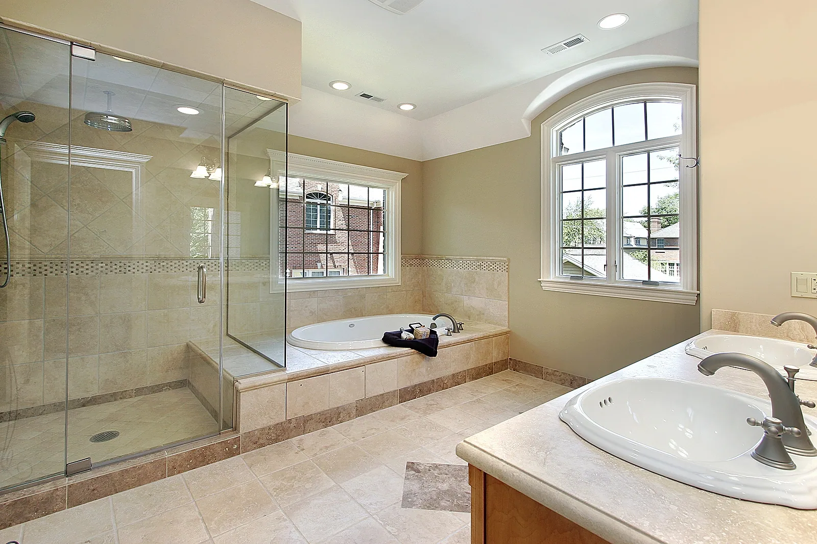 Frameless glass shower enclosure with a bench seat